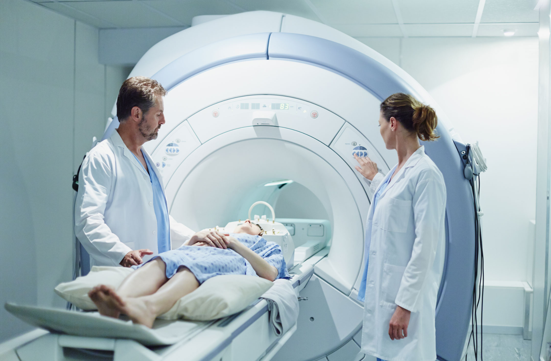 Two Doctors around patient bed during CAT Scan